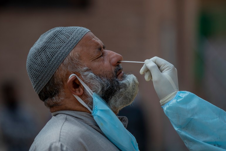 A Kashmiri health worker takes a nasal swab sample to test for COVID-19 in Srinagar, Indian-controlled Kashmir, Tuesday, Oct. 6, 2020. India is the second worst-nation in terms of confirmed coronavirus caseload. (AP Photo/ Dar Yasin)