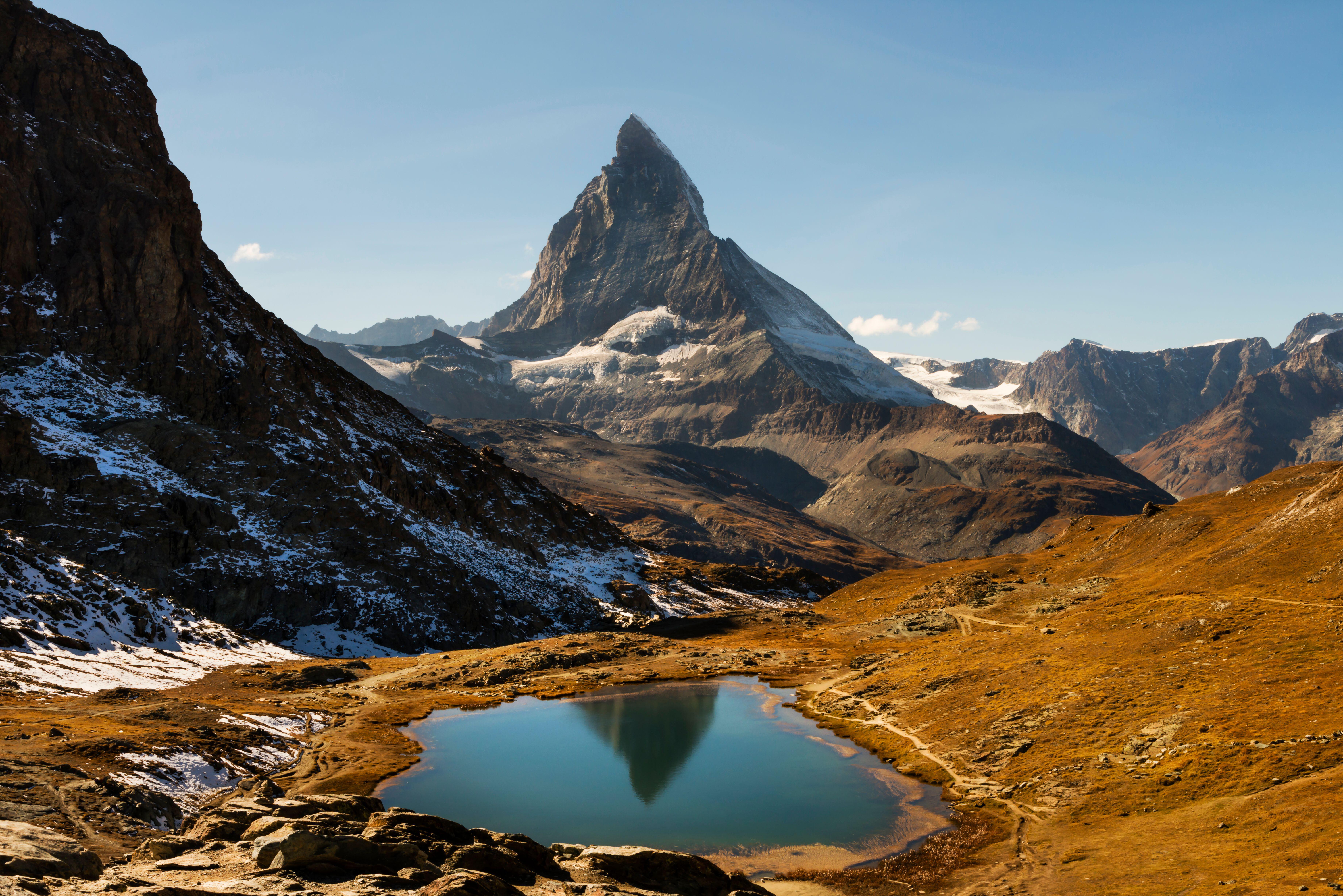 Matterhorn stands behind the Riffelsee Lake above Zermatt village in Switzerland