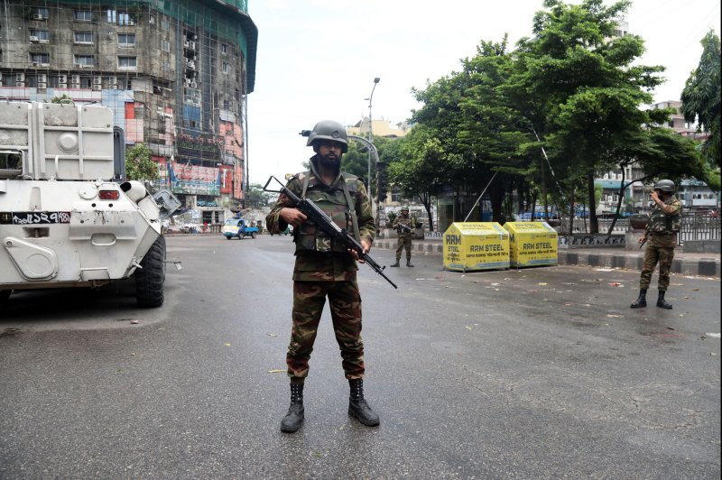 Bangladeshi troops stand guard in the capital, Dhaka, on Monday on day three of a national curfew imposed by the embattled government of Sheik Hasina in an effort to quell major unrest over quotas for government jobs. Security forces across the country were authorized to 'shoot on sight' to enforce the lockdown. Photo by Alam Monirul/EPA-EFE