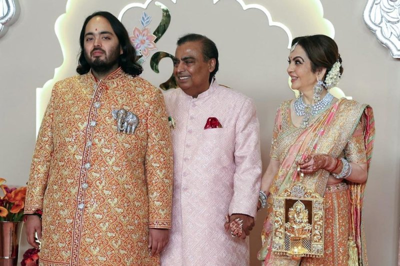 Reliance Industries chairman Mukesh Ambani (C) with his wife Neeta Ambani and their son and groom Anant Ambani pose for photographs before Anant's wedding in Mumbai, India, on Friday. Photo by Divyakant Solanki/EPA-EFE