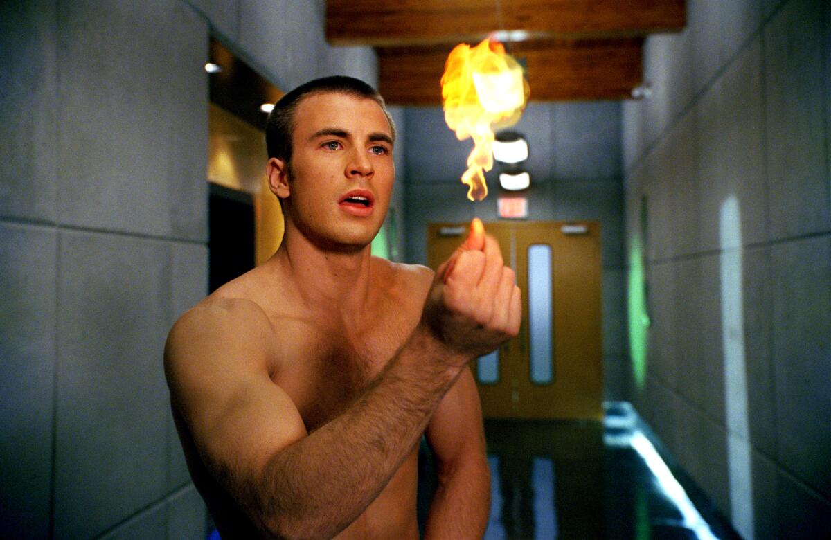 A shirtless Chris Evans snaps his fingers to create fire in "Fantastic Four."