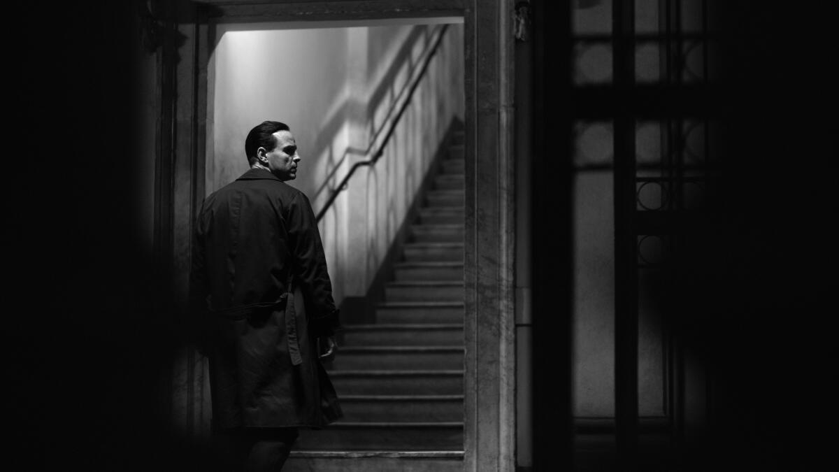 A man walks up a staircase in an apartment building in "Ripley."