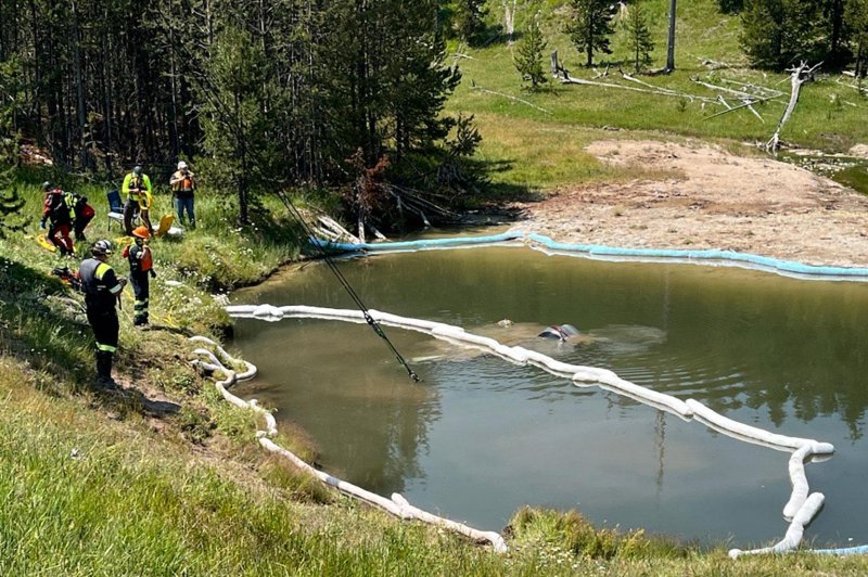 Officials in Yellowstone National Park have successfully removed a fully-submerged vehicle from a geyser, after the SUV went off the road and crashed, leaving the five occupants with non-life-threatening injuries. Photo courtesy of National Park Service