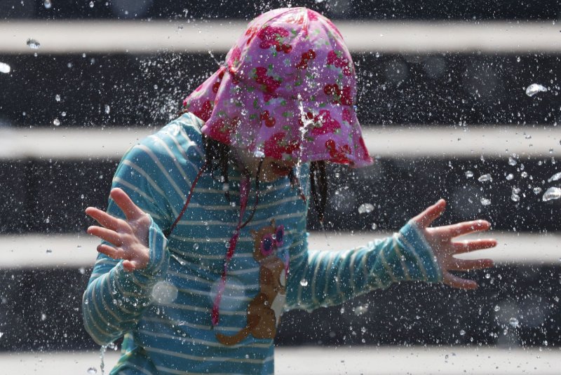 A child cools off in the fountain at Washington Square Park in New York City on Wednesday, June 19, 2024. An excessive heat watch has been issued for a large portion of the country during Independence Day. Photo by John Angelillo/UPI