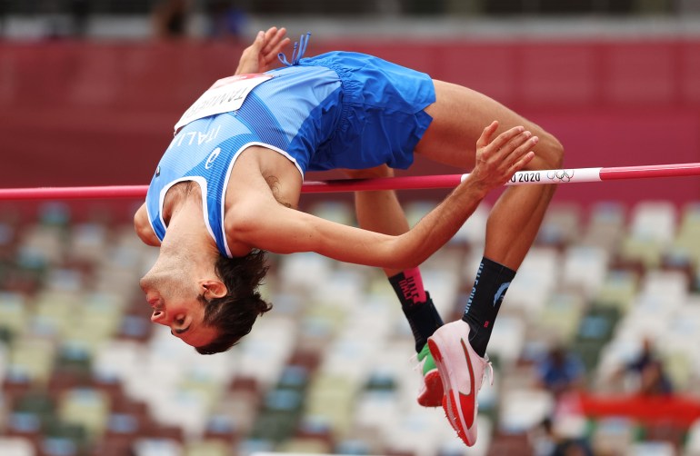 Athlete performs a high jump at Olympics.