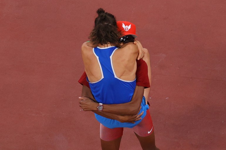 High jumpers embrace.