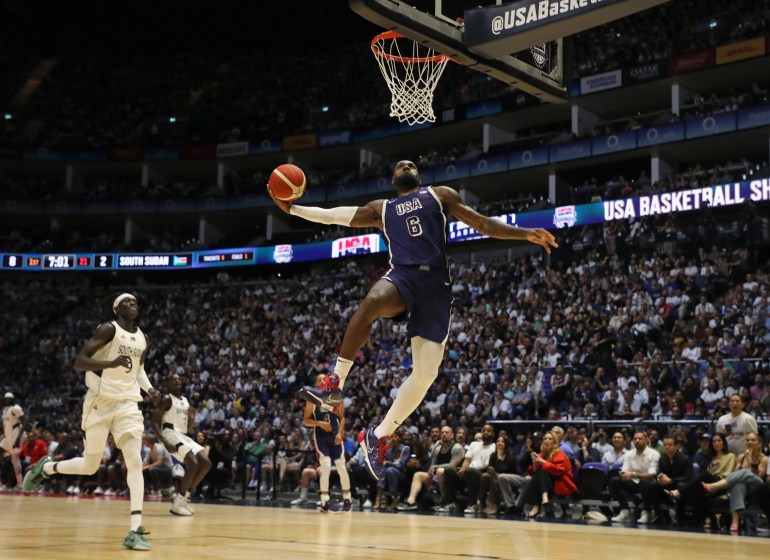 LeBron James dunks ball.