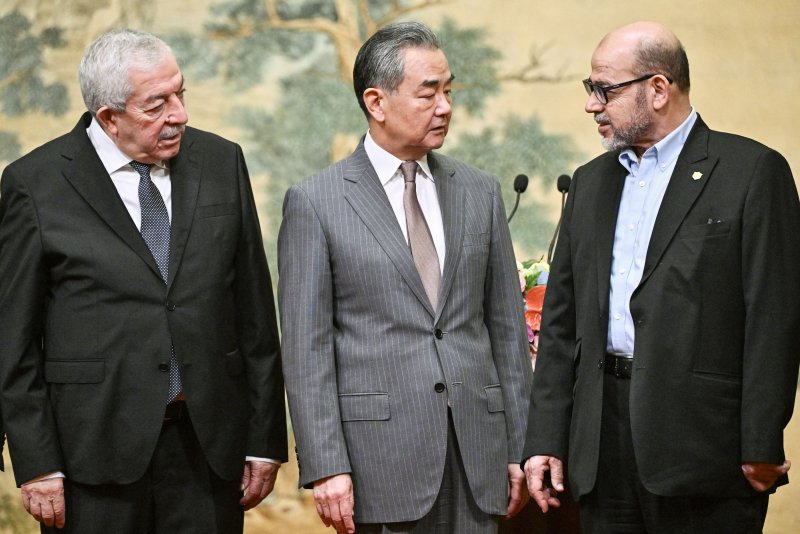 Fatah vice chairman Mahmoud al-Aloul, Chinese Foreign Minister Wang Yi, and senior Hamas negotiator Mousa Abu Marzook at the Diaoyutai State Guesthouse in Beijing on Tuesday after 14 Palestinian groups signed an agreement to set up an interim national reconciliation government to administer Gaza after the war ends. Photo by Predro Pardo/EPA-EFE