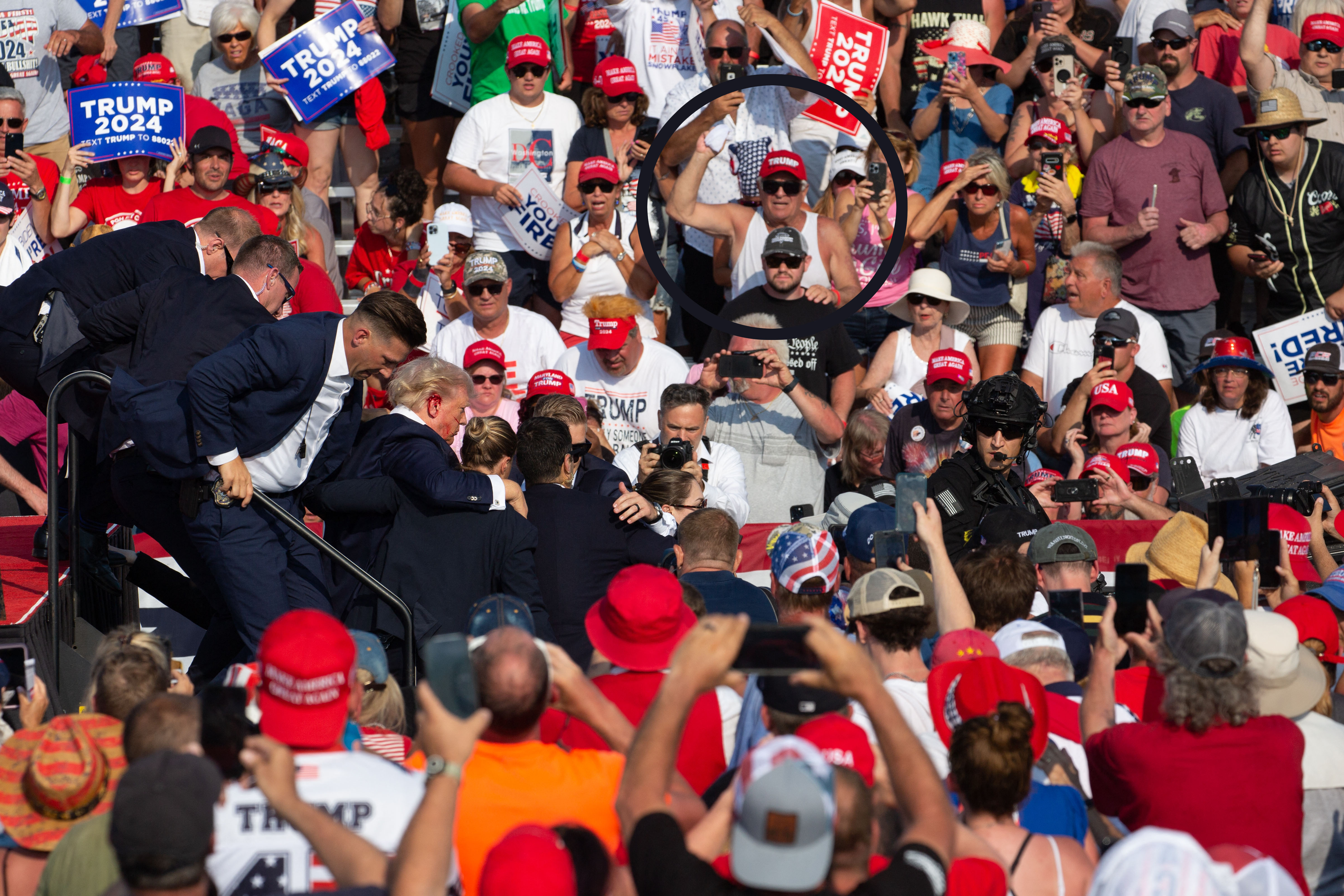 Donald Trump supporter Mike Costanzo (circled) is seen as the Republican candidate is carried off the stage after being hit by a bullet at his rally in Butler, Pennsylvania