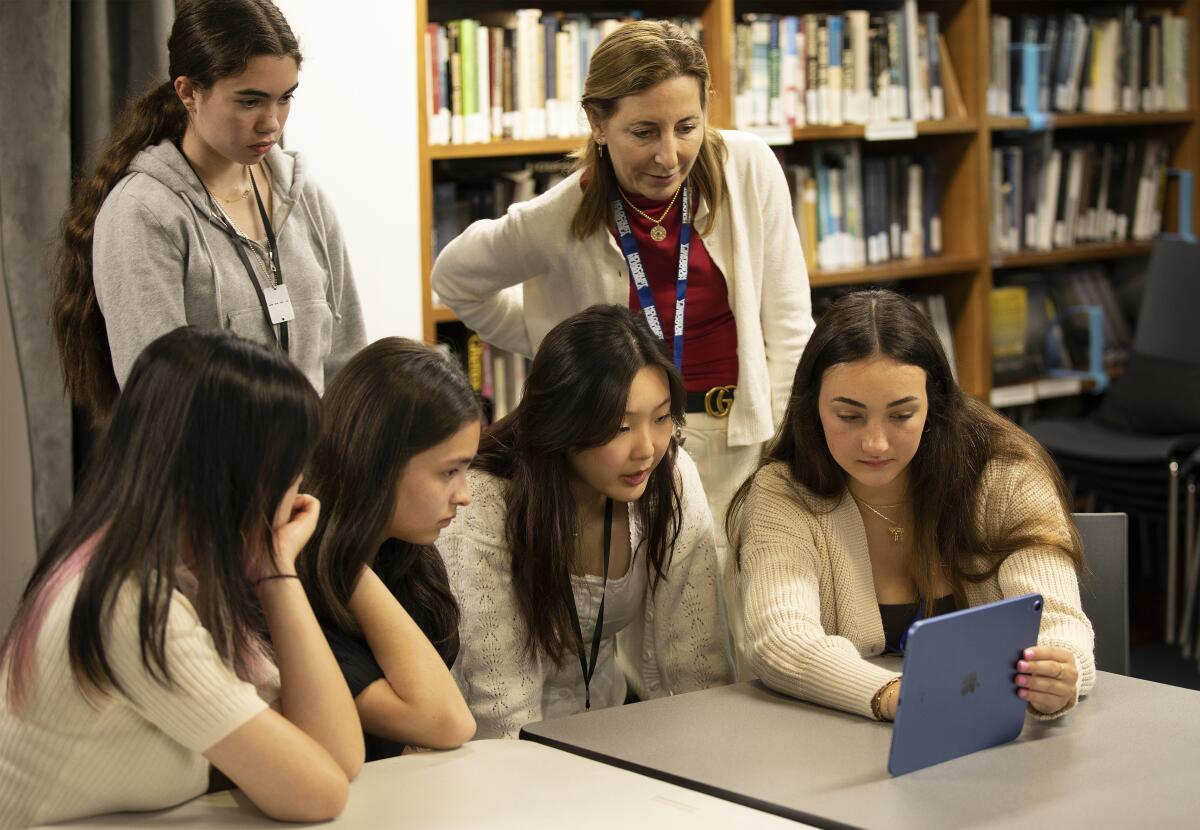 Young people look at an app on a tablet at Holocaust Museum L.A..