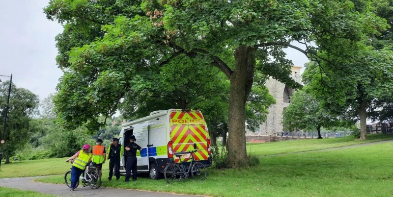 Police in Bristol talk to bicyclers with the Clifton Suspension Bridge behind them where on Wednesday two suitcases containing human remains were found. On Monday, Yostin Andres Mosquera was charged with two counts of murder in connection to the incident. Photo courtesy of Avon and Somerset Police/Release