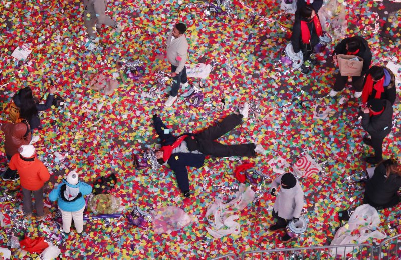 A reveler lies in confetti in Times Square for the New Year's Eve celebrations in New York City on Jan 1. Federal prosecutors on Tuesday charged a Georgian national with having plotted a mass causality event to take place on New Year's Even in New York City. Photo by John Angelillo/UPI