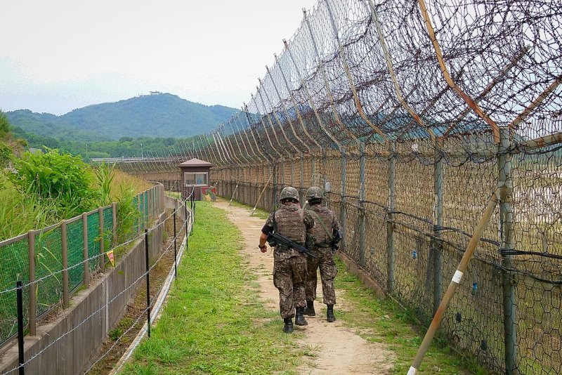 Soldiers walk alongside a barbed-wire fence in Goseong, South Korea, in 2019. A group of North Korean escapees recently have been pushing for a change in U.S. policy toward North Korea in meetings with officials and policy experts in Washington, D.C., and New York. File Photo by Thomas Maresca/UPI