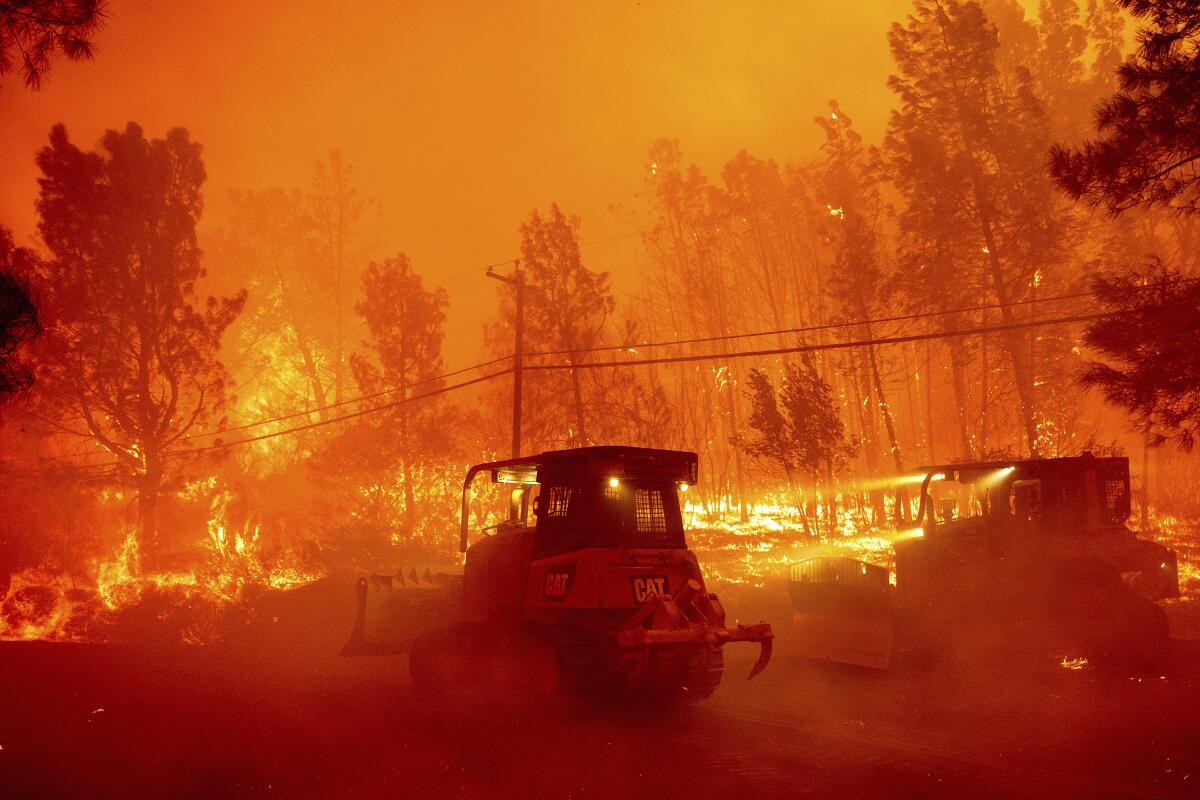 A hillside burns as the Park Fire tears though the Cohasset community