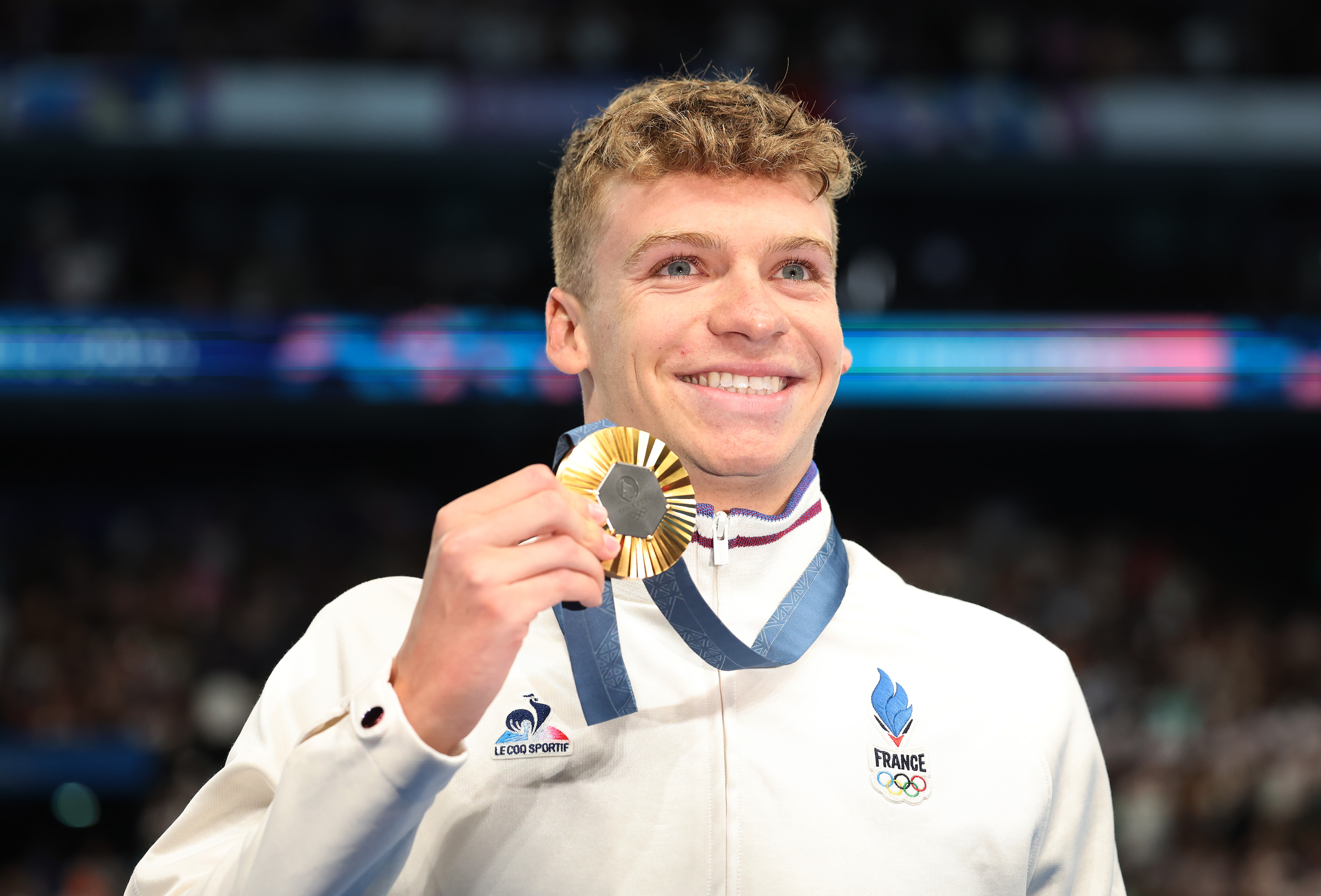 Leon Marchand of Team France poses with his Gold medal after victory