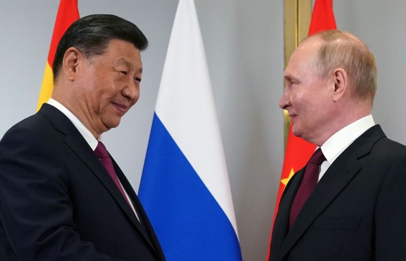 Russian President Vladimir Putin (R) and Chinese President Xi Jinping shake hands as they pose for photos during their meeting on the sidelines of the Shanghai Cooperation Organisation (SCO) summit in Astana, Kazakhstan, on Wednesday. Photo by Sputnik/Kremlin Pool/EPA-EFE