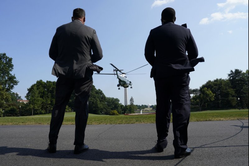 Secret Service agents watch as Marine One helicopter with President Joe Biden on board departs from the South Lawn of the White House in Washington, D.C., as he departs to Las Vegas on July 15. Photo by Yuri Gripas/UPI