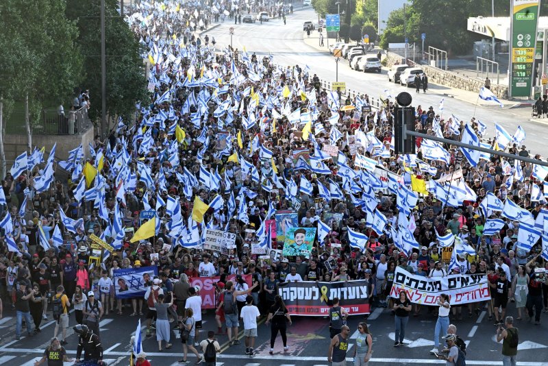 Families and supporters of hostages held in Gaza carry Israeli flags and placards as they enter Jerusalem on the final day of a four day march from Tel Aviv demanding a deal for the release of hostages on Saturday. Photo by Debbie Hill/ UPI