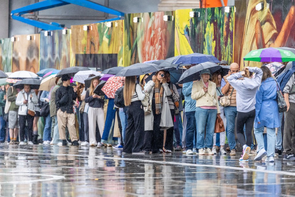 Miserable weather in London's Trafalgar Square yesterday