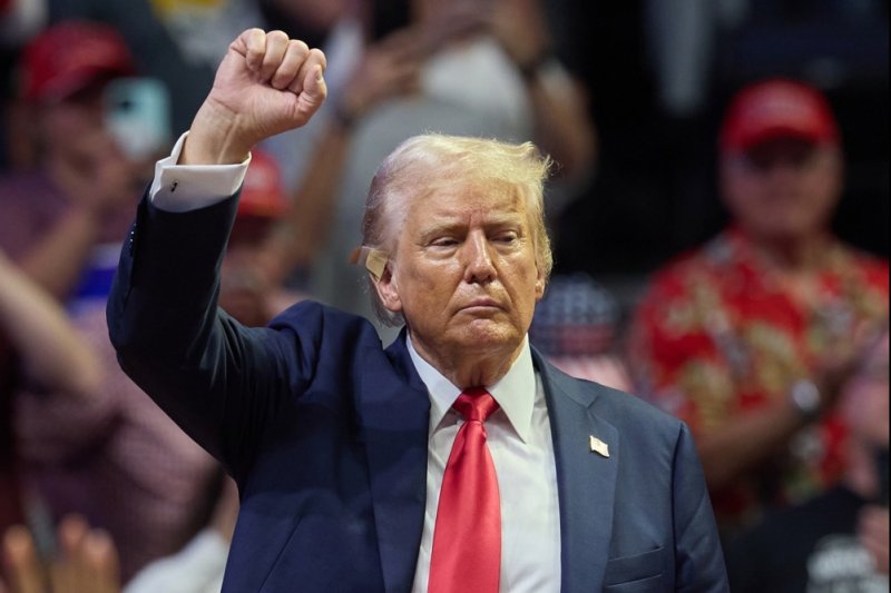 Republican presidential nominee Donald J. Trump holds his fist up after speaking at his first joint rally with Republican vice presidential nominee Sen. JD Vance at Van Andel Arena in Grand Rapids, Mich. on Saturday. Photo by Allison Dinner/EPA-EFE