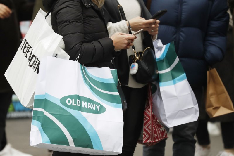 People carry shopping bags as they walk in Herald Square on Black Friday in New York City on November 26, 2021. A new Census Bureau report said that retail sales were flat in June. File Photo by John Angelillo/UPI