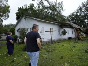 FILE - Ann McCauley, right, examines the damage at Bethel Church after Hurricane Beryl moved through the area July 8, 2024, in Van Vleck, Texas.