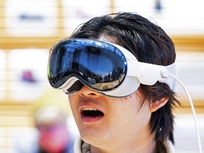 Apple's Vision Pro headset is expected to make its Canadian debut today. Bryan Chiang tries out an Apple Vision Pro headset during the first day of sales at a Palo Alto, Calif., Apple store on Friday, Feb. 2, 2024.