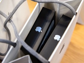 Apple iPhone 13 Pro smartphones inside a shopping bag at an Apple store in New York, U.S., on Sept. 24, 2021.