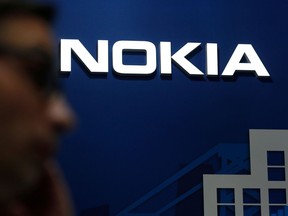 A man walks past the Nokia logo at the Mobile World Congress (MWC) in Barcelona on February 25, 2019.