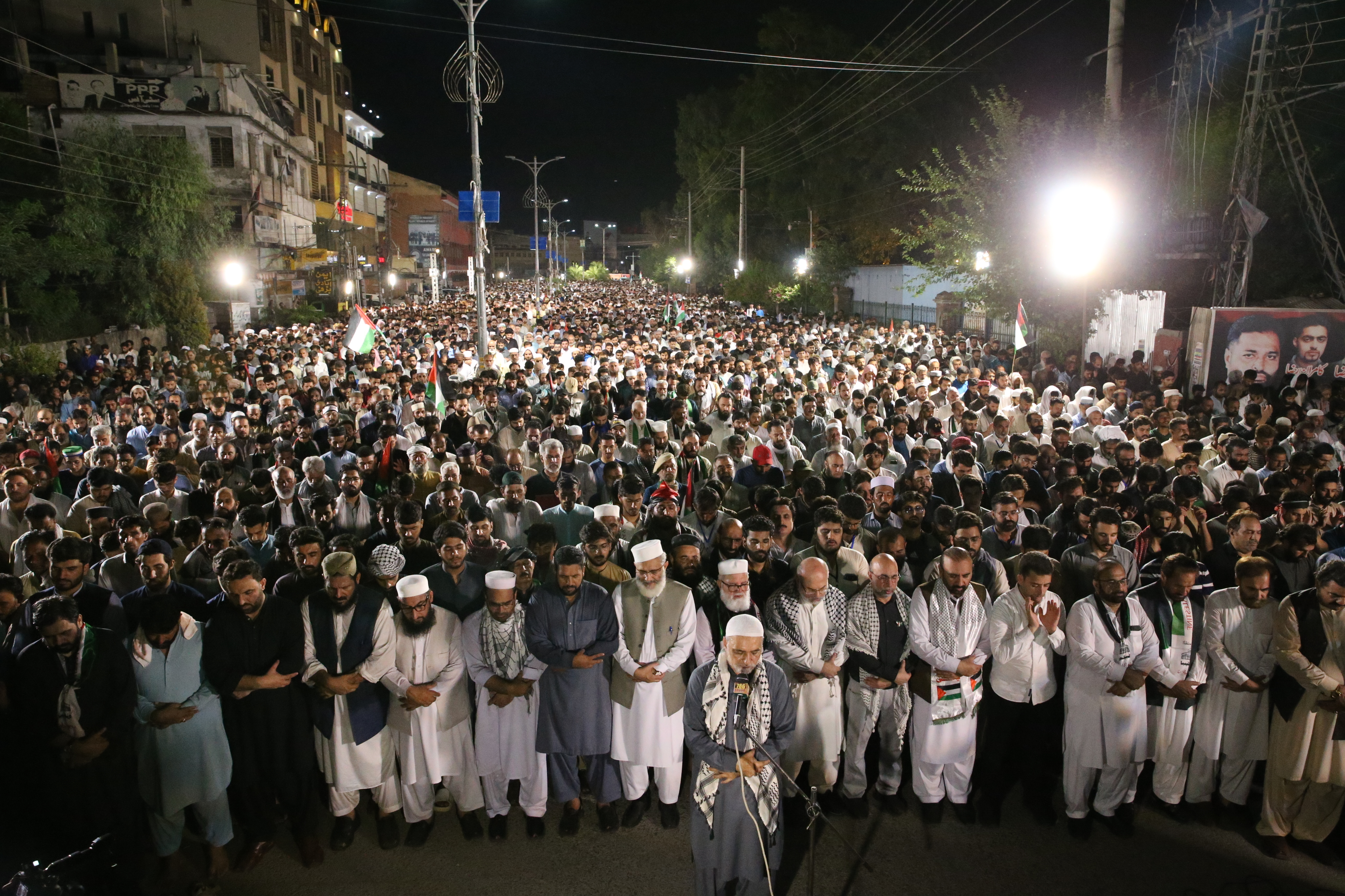 Thousands of Pakistani supporters attend a memorial for Haniyeh