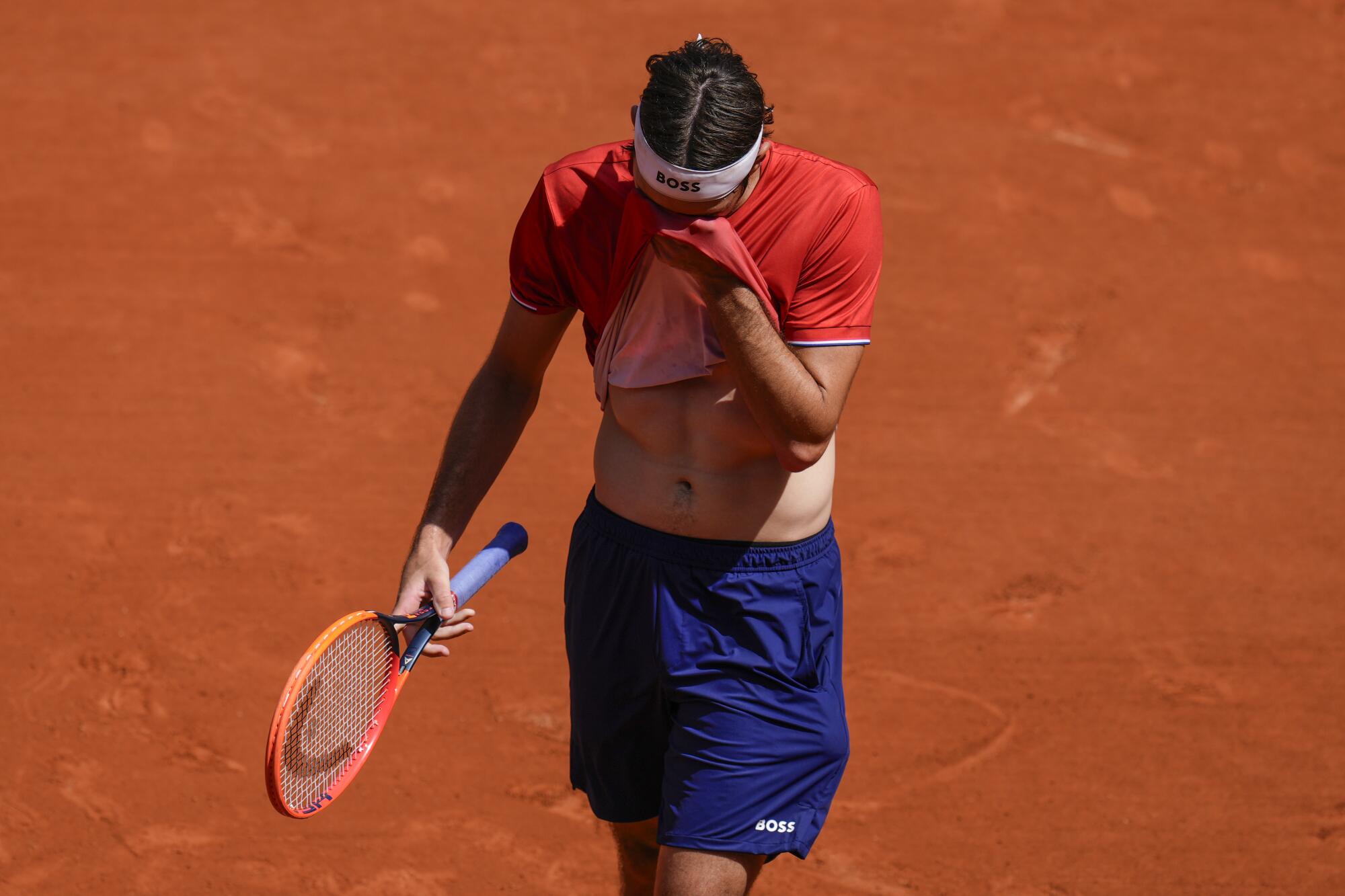 American Taylor Fritz wipes his face during a singles match against Jack Draper of Britain on Tuesday.