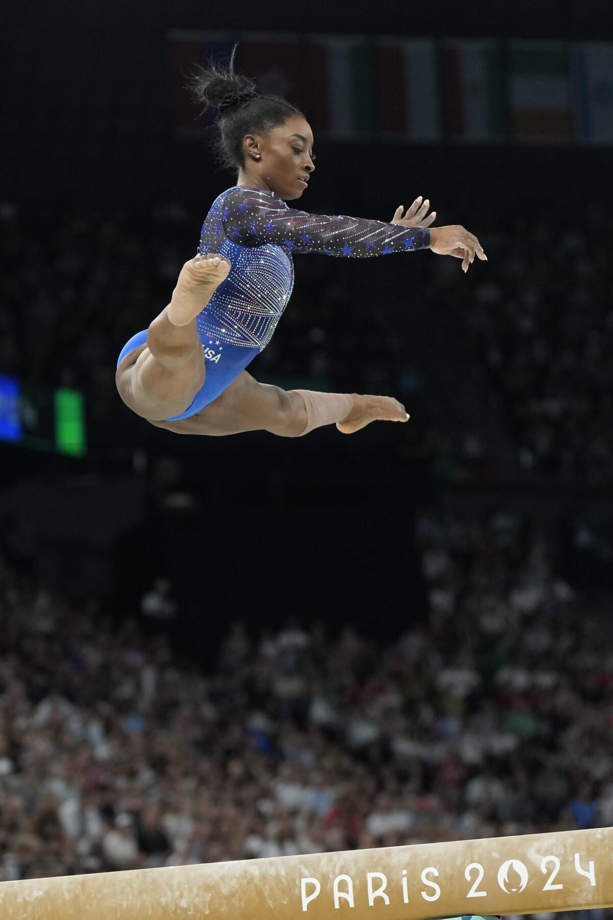 Simone Biles performs on the balance beam during the gymnastics individual all-around finals at the Paris Olympics.