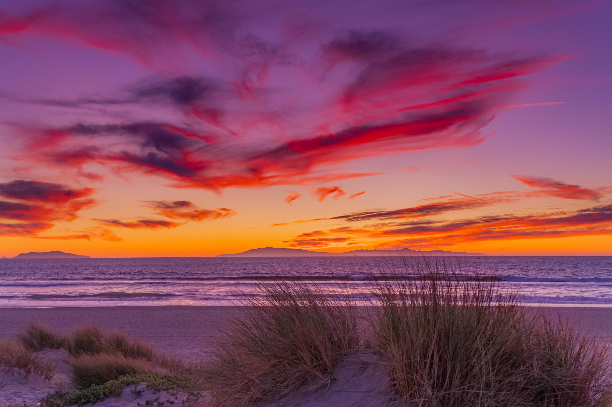 Pink and orange skies during sunset over the ocean. 