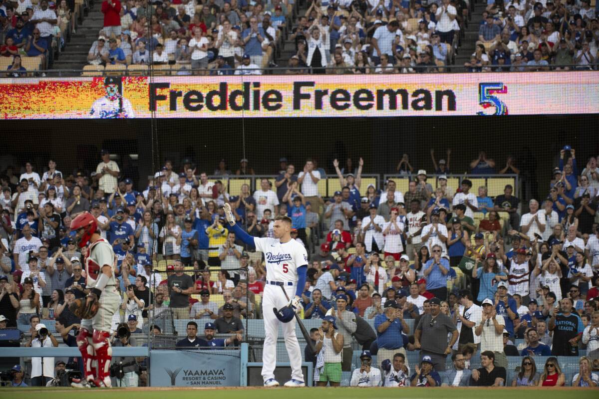 Freddie Freeman reacts to a standing ovation before his first at-bat Monday.