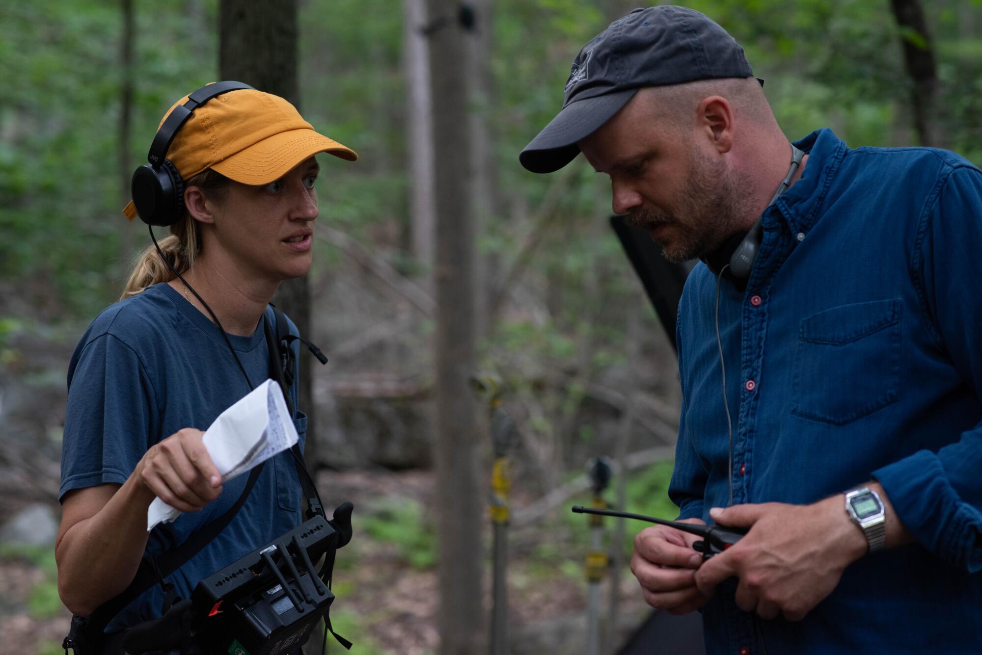 A director confers with her producer on an exterior shoot.