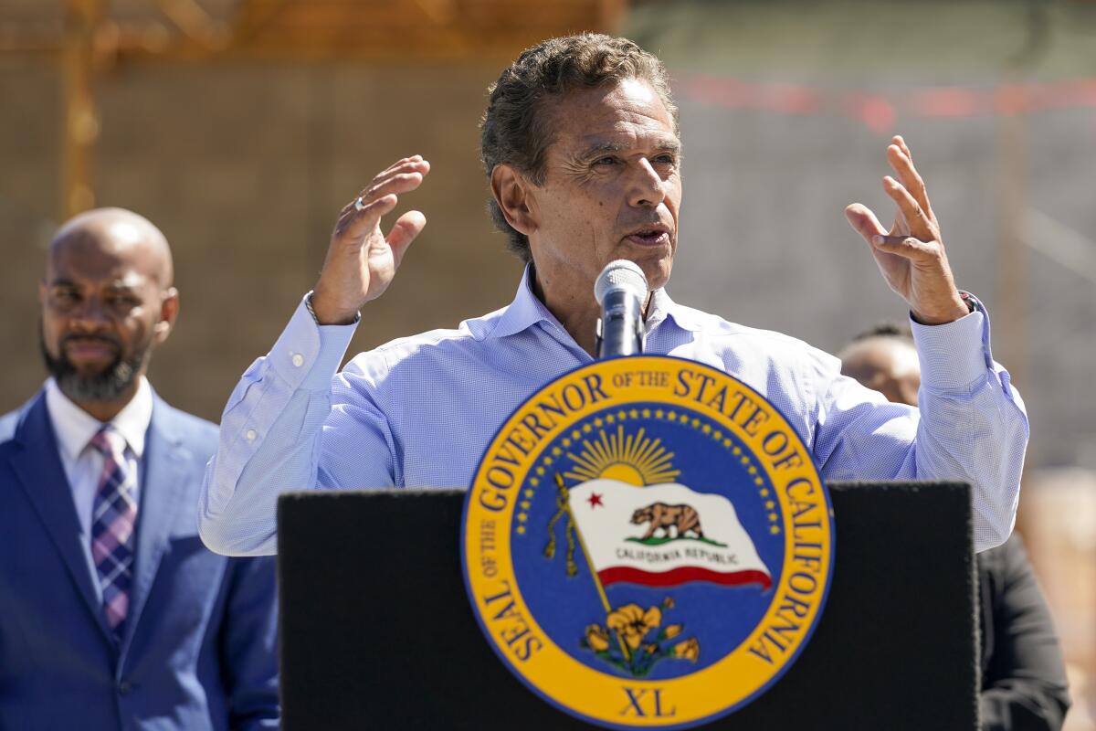 A man speaks at a lectern bearing the California governor's seal.