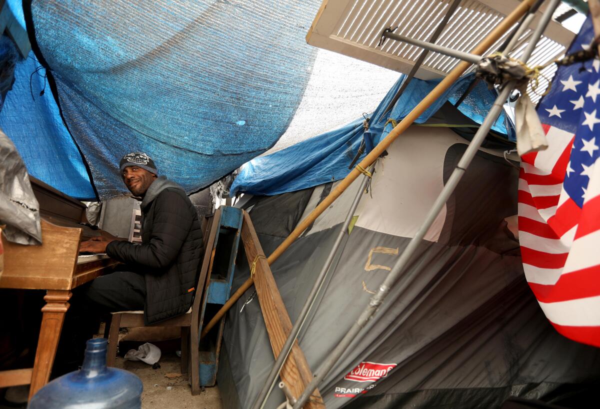  Iraq war veteran Lavon Johnson, 35, plays his piano inside his tent along Veterans Row enaro Molina / Los Angeles Times)