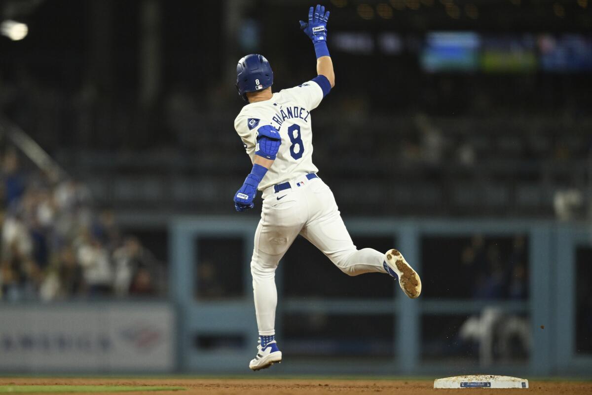 The Dodgers' Kiké Hernández waves to left field after hitting a two-run home run against the Pirates Friday