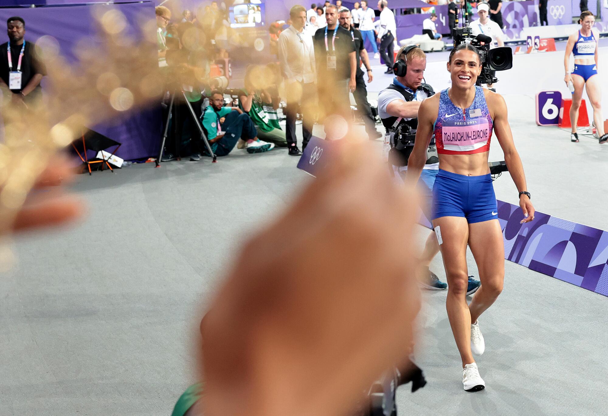 -USA's Sydney McLaughlin-Levrone receives a crown from her sister after winning the 
