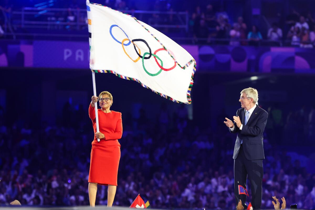 L.A. Mayor Karen Bass waves the Olympic flag during the closing ceremony of the 2024 Paris Olympics Sunday.