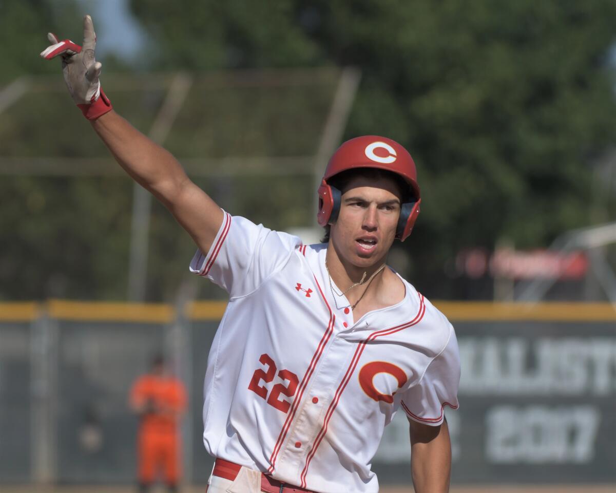 Corona High's Seth Hernandez circles the bases after hitting a two-run hoe run against visiting Huntington Beach on Tuesday.