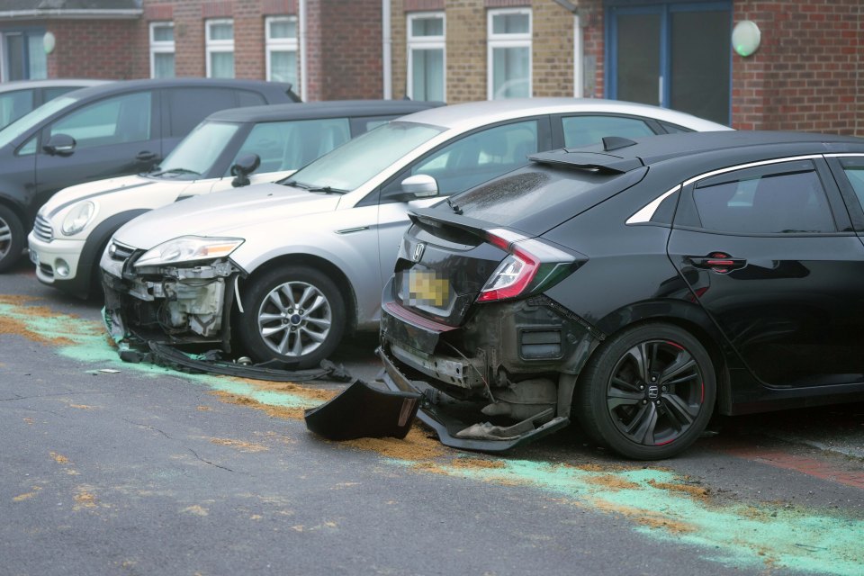 Several cars parked along the street were damaged