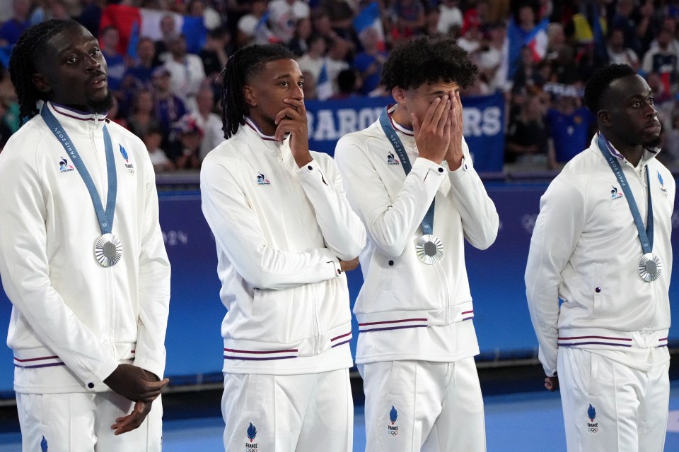 Thiery Henry's troops cut dejected figures as they were awarded their silver medals