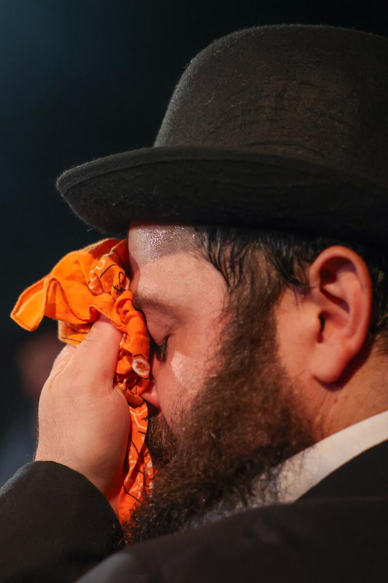 Daddario wipes sweat from his face while performing.