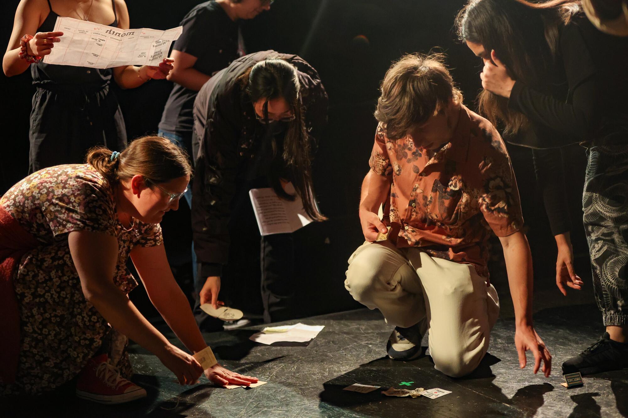 Audience members look on the ground for context clues to solve the next puzzle.