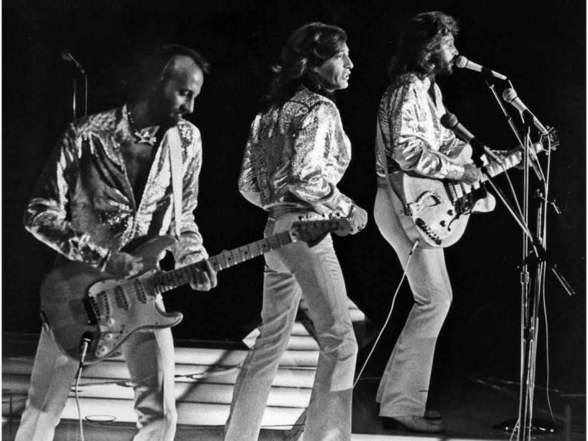 The Bee Gees perform at Dodger Stadium July 7, 1979. From left are Maurice, Robin and Barry Gibb.