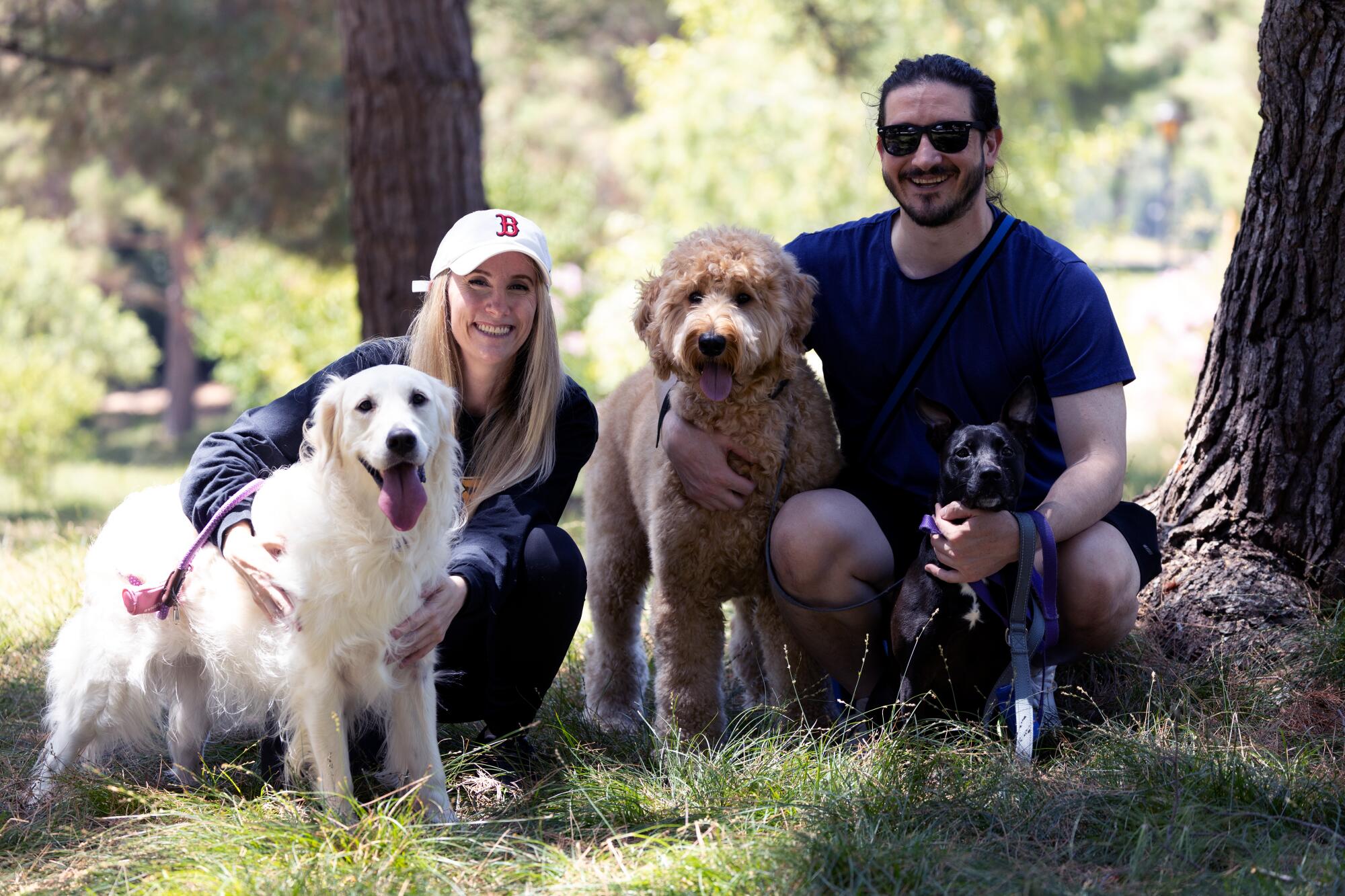 Kim Pohas, left, and her boyfriend Dustin Swad, with their dogs in Irvine.