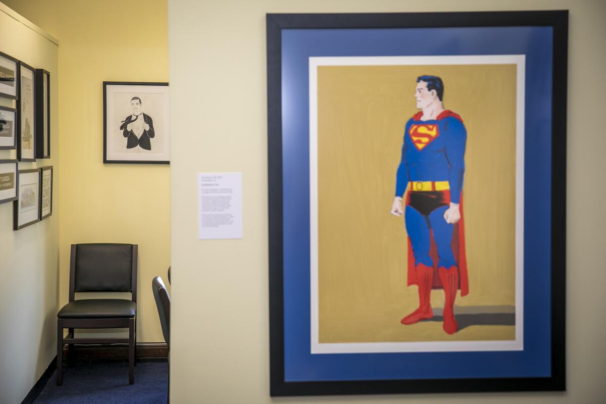 A framed painting of Superman on a wall in a home.