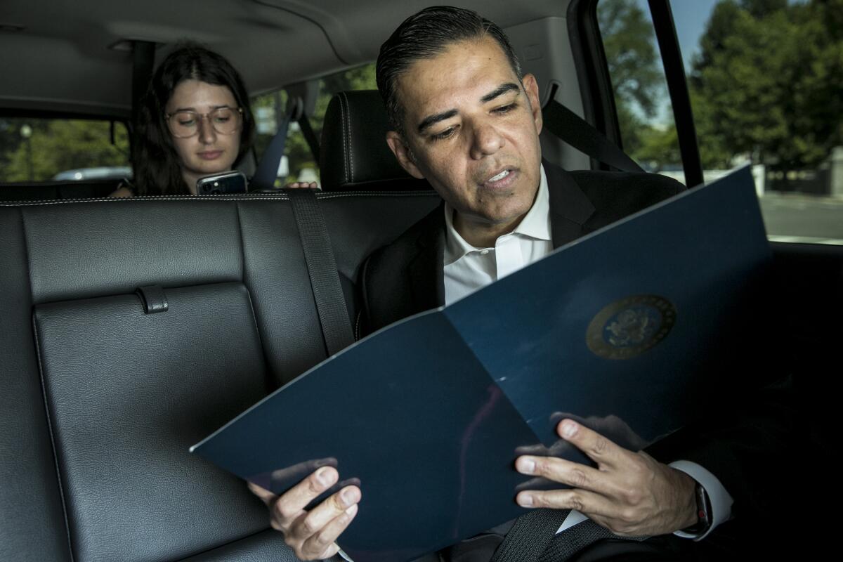 Robert Garcia reviews notes while sitting in a car