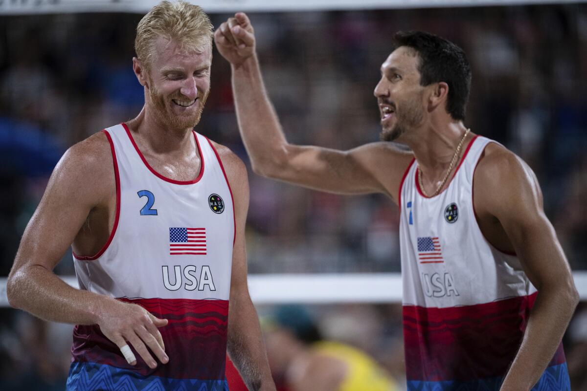 Americans Miles Evans and Chase Budinger react during the men's lucky loser beach volleyball match 